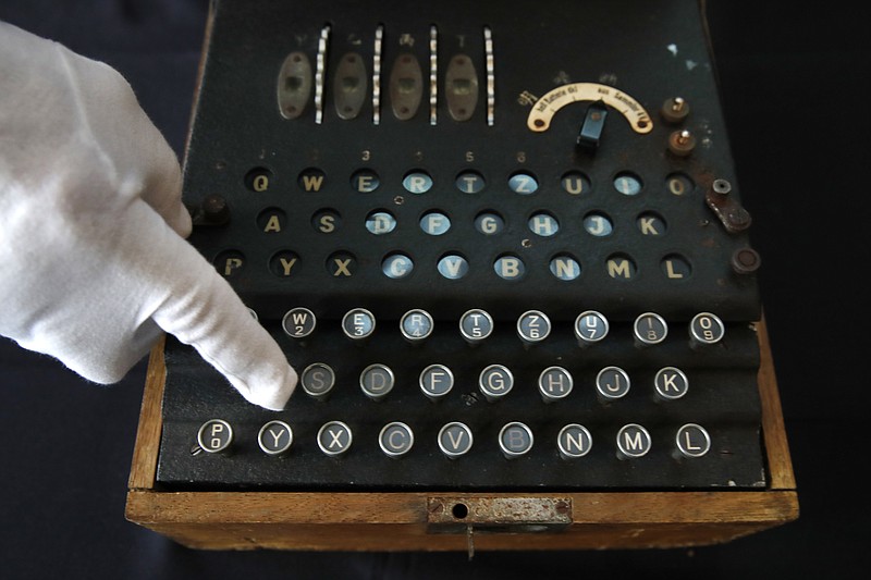 
              H. Keith Melton points to a key on an Enigma Machine with four rotors and a some Japanese characters that was used in World War II to encode messages, Wednesday, Sept. 13, 2017, in Washington. The machine is one of the many items that he is donating to the International Spy Museum from his collection of spy objects. (AP Photo/Jacquelyn Martin)
            