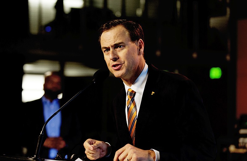 Tennessee athletic director John Currie  speaks during a press conference Thursday, Sept. 14, 2017, in Knoxville, Tenn. Currie says athletes for all women’s sports at the school can refer to themselves as the Lady Volunteers, changing a decision his predecessor made three years ago.  (Calvin Mattheis/Knoxville News Sentinel via AP)