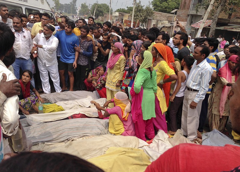 
              Villagers protest with dead bodies of victims of a boat capsize as they block traffic on the Delhi-Saharanpur highway at Katha village near Baghpat town in Uttar Pradesh state, India, Thursday, Sept.14, 2017. A boat crowded with construction workers capsized in the Yamuna River early Thursday and nineteen bodies have been pulled out of the river so far. (AP Photo/Altaf Qadri)
            