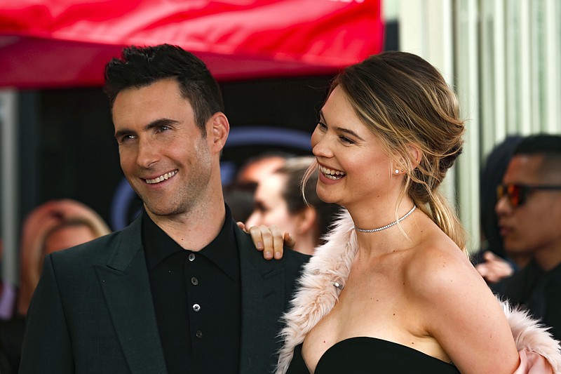 
              FILE - In this Feb. 10, 2017, file photo, Adam Levine, left, and his wife Behati Prinsloo smile at a ceremony that honored him with a star on the Hollywood Walk of Fame in Los Angeles. Levine's publicist confirmed to the AP on Sept. 14, 2017, that the couple is expecting a second child. (Photo by Willy Sanjuan/Invision/AP, File)
            