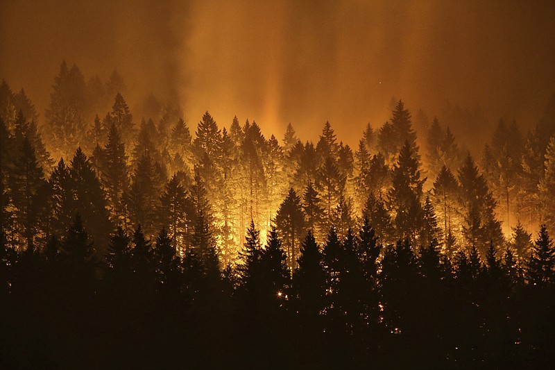 
              FILE - In this Sept. 5, 2017, file photo, the Eagle Creek wildfire burns on the Oregon side of the Columbia River Gorge near Cascade Locks, Ore. Wildfires that have blackened more than thousands of square miles across the American West have also ignited calls, including from Interior Secretary Ryan Zinke, for thinning of forests that have become so choked with trees that they're at "powder keg levels." (Genna Martin /seattlepi.com via AP, File)
            