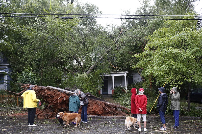 A large tree lays on top of a house on Boulevard after heavy winds and rain from tropical storm Irma hit Athens, Ga., Tuesday, Sept. 12, 2017. (Joshua L. Jones/Athens Banner-Herald via AP)