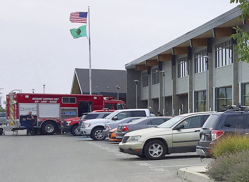 Cars and emergency vehicles are seen in front of Freeman High School in Rockford, Wash., Wednesday, Sept. 13, 2017. Authorities say a shooter opened fire at the school. A suspect was apprehended. (AP Photo/Nicholas K. Geranios)