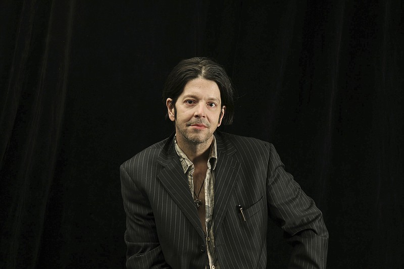 In this Oct. 6, 2009 photo, former Husker Du drummer Grant Hart poses for a photo in Minneapolis. Hart, 56, died late Wednesday, SEPT. 13, 2017, at a Minneapolis hospital from complications of liver cancer and hepatitis C, his wife, Brigid McGough, said in an email to Minnesota Public Radio's The Current. (Elizabeth Flores/Star Tribune via AP)