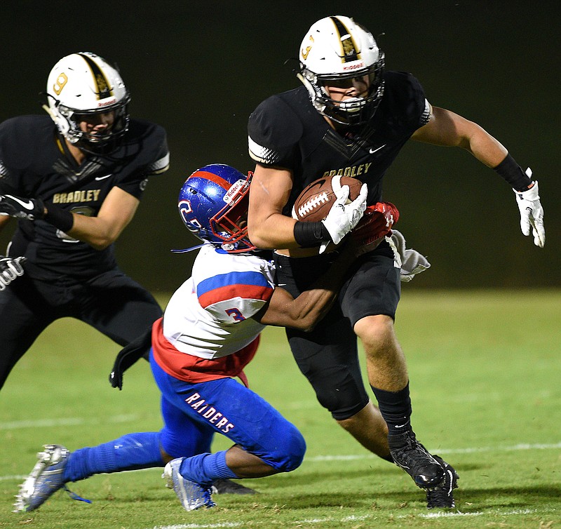 Braldey's Nick Howell (3) is tackled by Cleveland's Treasure Johnson (3).  The Cleveland Blue Raiders visited the Bradley Central Bears in TSSAA football action of September 15, 2017. 