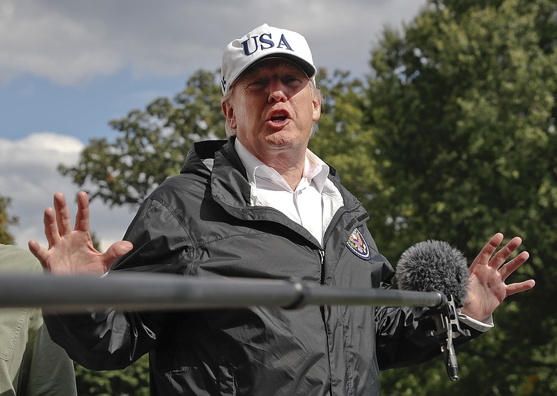 
              President Donald Trump answers a question from the media as he arrives at the White House, Thursday, Sept. 14, 2017, in Washington. Trump is returning from Florida after viewing damage from Hurricane Irma. (AP Photo/Alex Brandon)
            