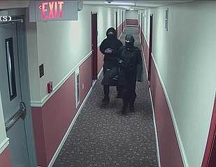 
              This still image provided by City of Newark Public Safety shows two suspects wanted for arson in an apartment building in Newark, N.J.    Police say two people dressed as ninjas broke into a New Jersey apartment building and set several fires.
Newark police officials say the unidentified man and woman broke in through a second-floor apartment  Police say the building's sprinkler system quickly doused the flames. No one was injured. (Newark Public Safety via AP)
            