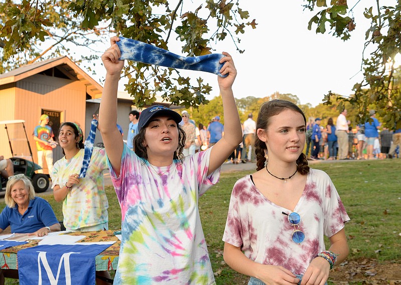 (Photo by Mark Gilliland) Kalli Agudo and Molly Milam sale spirits socks to help childhood cancer before the McCallie's game against Ensworth on September 15, 2017.