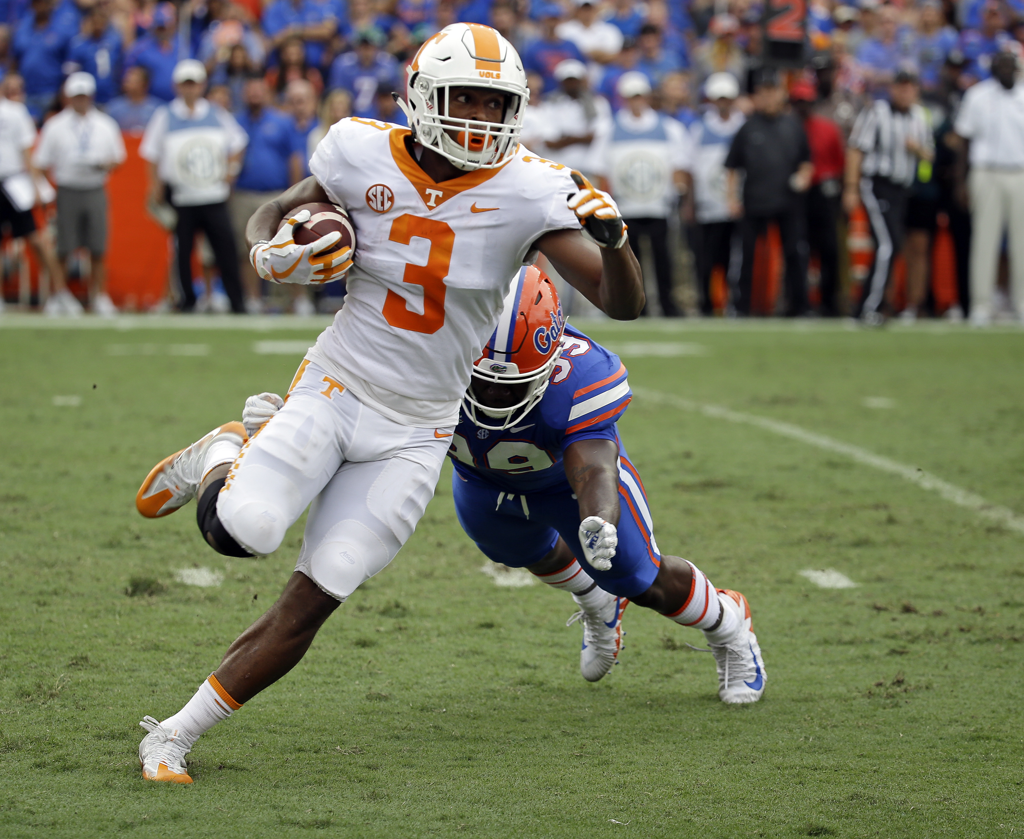 Tennessee running back Ty Chandler (3) slips past Florida defensive lineman Jachai Polite for short yardage during the first half of an NCAA college football game, Saturday, Sept. 16, 2017, in Gainesville, Fla. (AP Photo/John Raoux)
