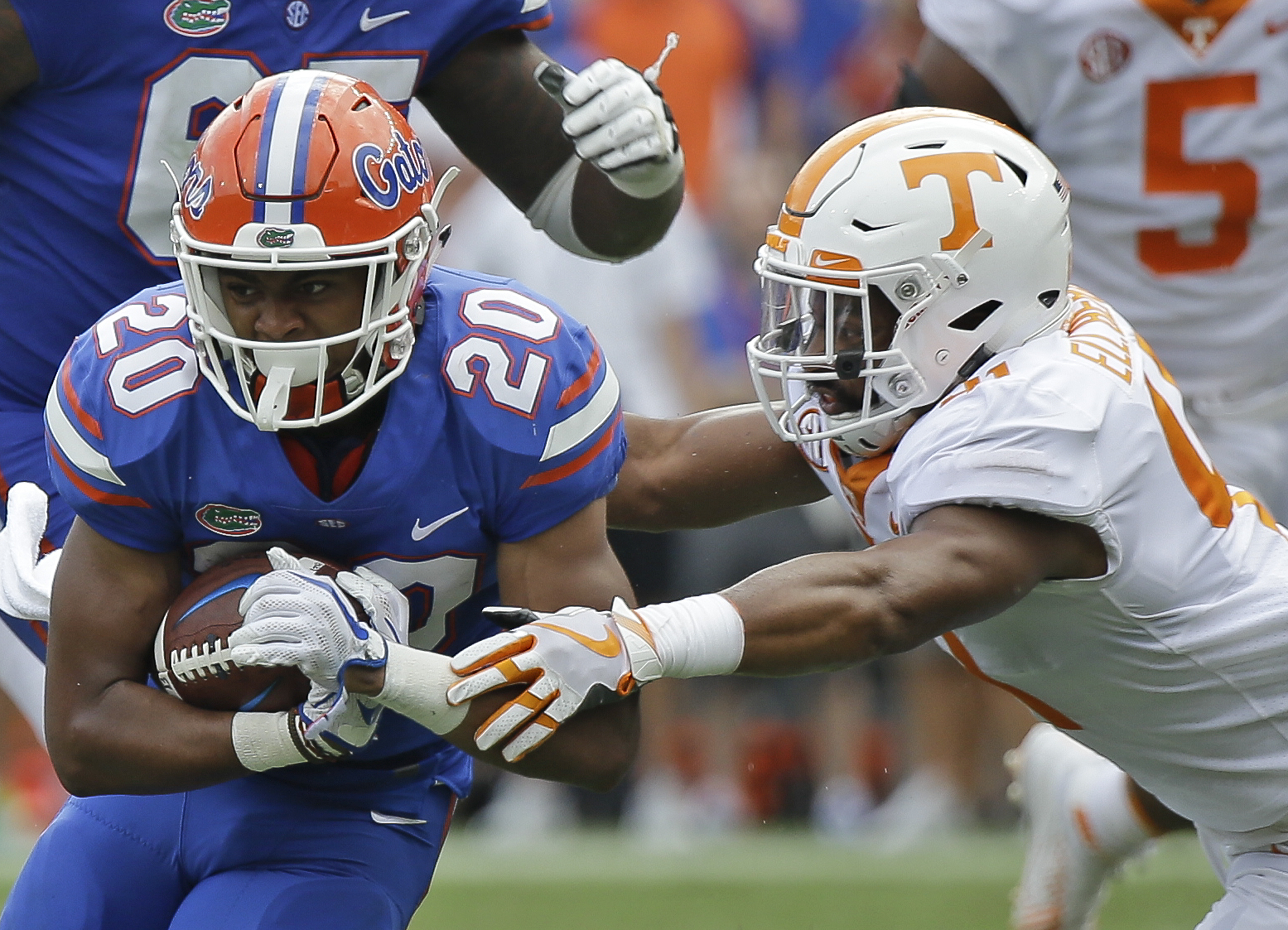 Florida running back Malik Davis (20) tries to get past Tennessee linebacker Elliott Berry, right, during the first half of an NCAA college football game, Saturday, Sept. 16, 2017, in Gainesville, Fla. (AP Photo/John Raoux)