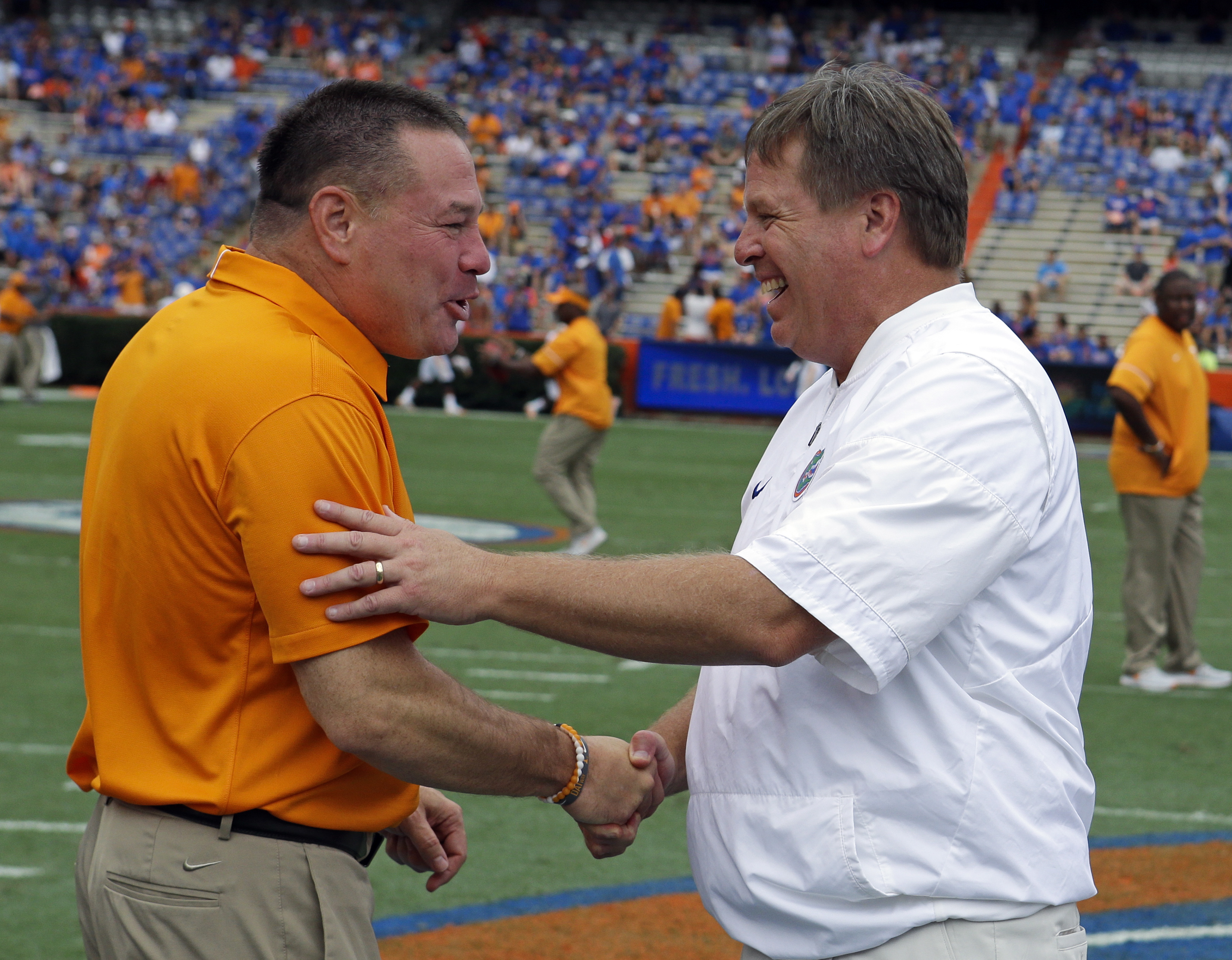 Tennessee head coach Butch Jones, left, and Florida head coach Jim McElwain greet each other at midfield before an NCAA college football game Saturday, Sept. 16, 2017, in Gainesville, Fla. (AP Photo/John Raoux)