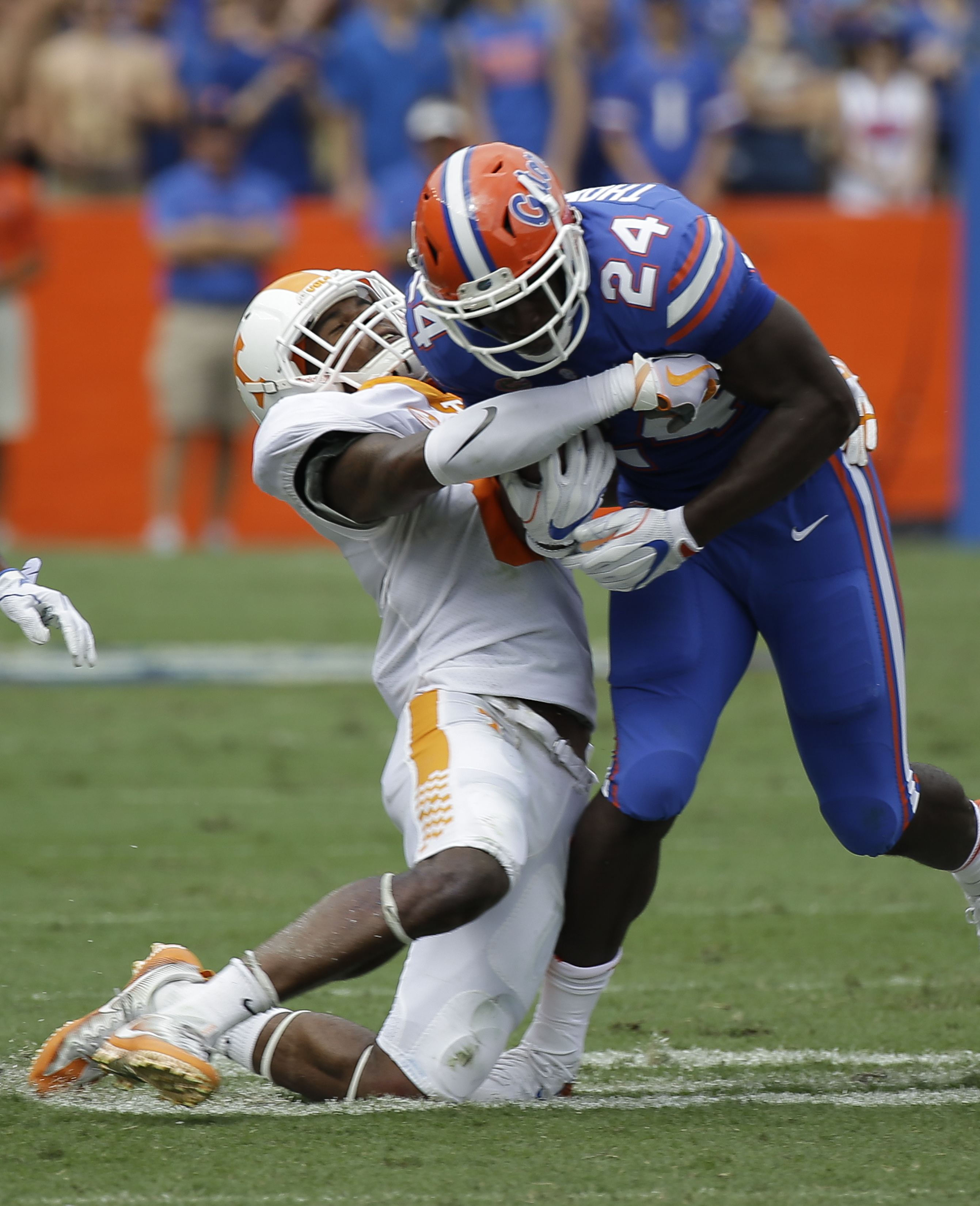 Tennessee's Justin Martin, left, tries to stop Florida running back Mark Thompson (24) after a short gain during the first half of an NCAA college football game, Saturday, Sept. 16, 2017, in Gainesville, Fla. (AP Photo/John Raoux)