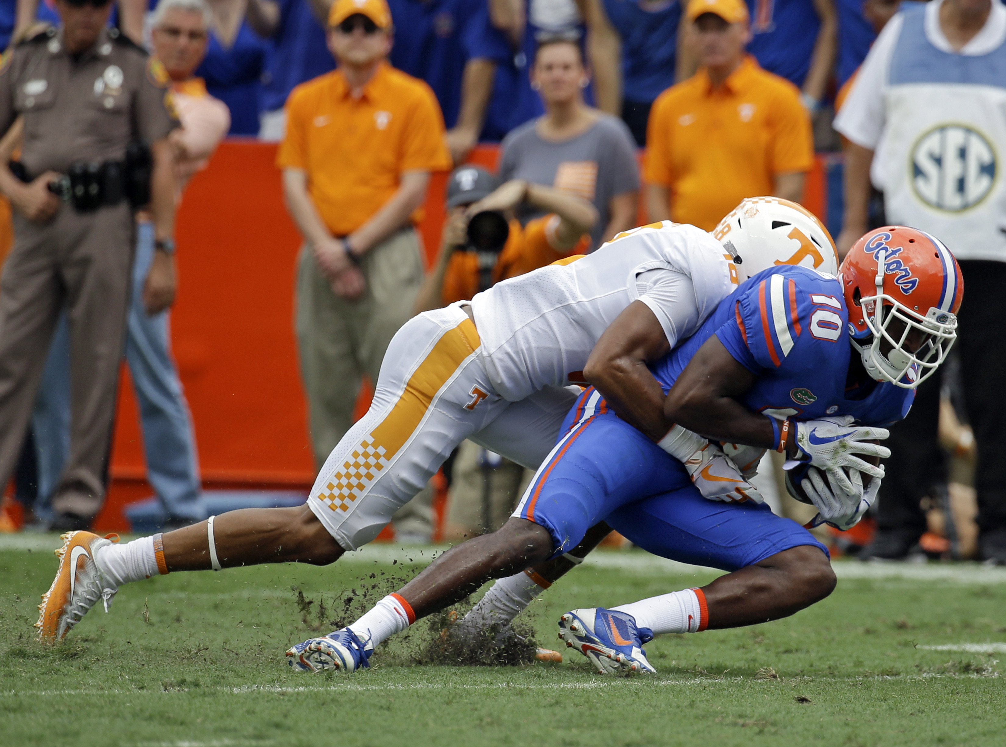 Florida wide receiver Josh Hammond (10) is stopped by Tennessee defensive back Nigel Warrior after a reception during the first half of an NCAA college football game, Saturday, Sept. 16, 2017, in Gainesville, Fla. (AP Photo/John Raoux)