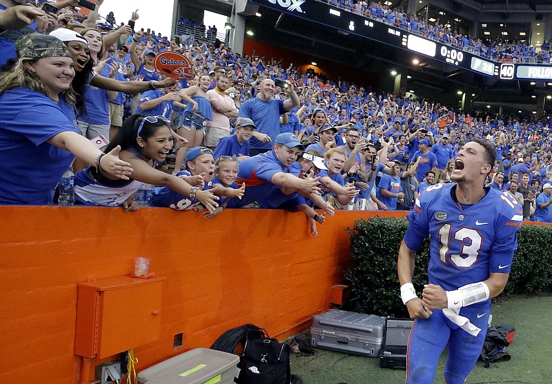 Florida quarterback Feleipe Franks celebrates with fans after he threw a 63-yard touchdown pass as time expired in the Gators' 26-20 win against Tennessee on Saturday in Gainesville, Fla.