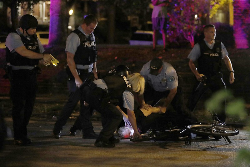 
              Police arrest a protester as protesters gather, Friday, Sept. 15, 2017, in St. Louis, after a judge found a white former St. Louis police officer, Jason Stockley, not guilty of first-degree murder in the death of a black man, Anthony Lamar Smith, who was fatally shot following a high-speed chase in 2011. (AP Photo/Jeff Roberson)
            