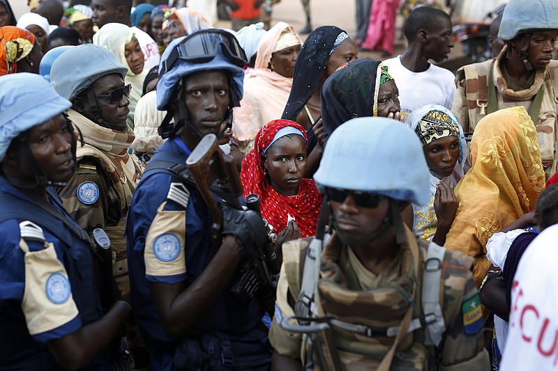 
              FILE- In this Nov. 30, 2015 file photo, UN soldiers stand near Muslims faithful queuing to enter the Central Mosque on the occasion of Pope Francis' visit, in Bangui's Muslim enclave of PK5, Central African Republic. The United Nations peacekeeping mission in the Central African Republic is requesting about 750 more troops, according to a confidential cable obtained by the Associated Press. (AP Photo/Jerome Delay, File)
            