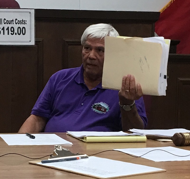 Jasper, Tenn., Mayor Paul Evans displays a folder full of certified letters that he says he's sent out to landowners trying to get them to clean up their properties.