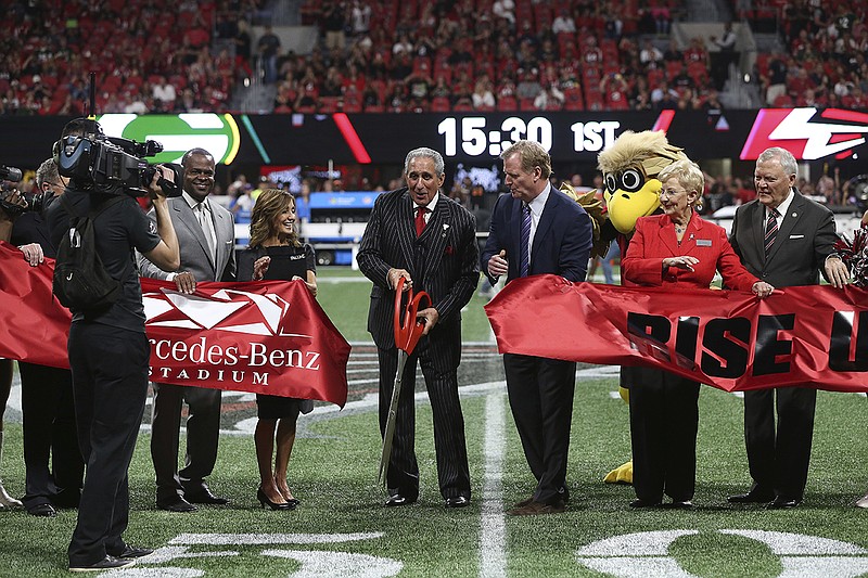 From left, Atlanta Mayor Kasim Reed, Angela Macuga, Atlanta Falcons owner Arthur Blank, NFL commissioner Roger Goodell, Sandra Dunagan and Georgia Gov. Nathan Deal walk to the center of the field for a ribbon cutting before the Falcons' game against the Green Bay Packers on Sunday night in Atlanta.