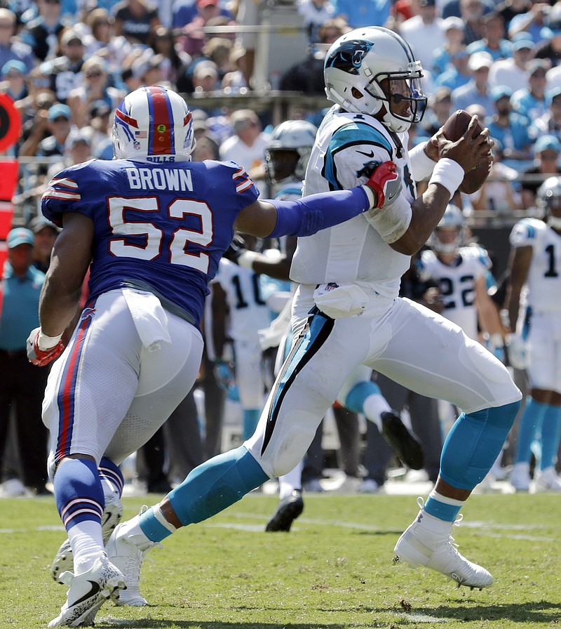 
              Carolina Panthers' Cam Newton (1) tries to avoid Buffalo Bills' Preston Brown (52) in the second half of an NFL football game in Charlotte, N.C., Sunday, Sept. 17, 2017. (AP Photo/Bob Leverone)
            