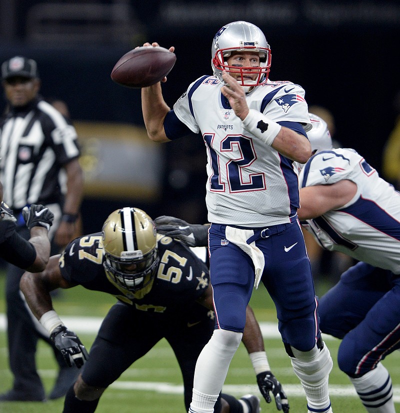 
              New England Patriots quarterback Tom Brady (12) passes under pressure from New Orleans Saints defensive end Alex Okafor (57) in the first half of an NFL football game in New Orleans, Sunday, Sept. 17, 2017. (AP Photo/Bill Feig)
            