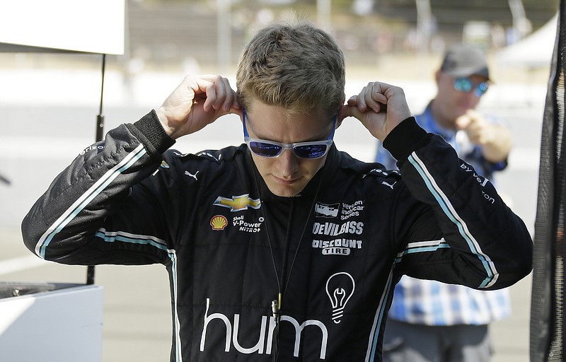 Josef Newgarden prepares to get into his car for a warm up before the start of the IndyCar auto race Sunday, Sept. 17, 2017, in Sonoma, Calif. (AP Photo/Eric Risberg)