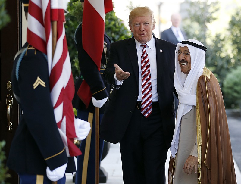 
              FILE- In this Thursday, Sept. 7, 2017 file photo, President Donald Trump, center, gestures as he greets the Amir of Kuwait Sheikh Sabah Al Ahmad Al Sabah as he arrives at the White House in Washington. Kuwait says it will expel North Korea's ambassador and four other diplomats from its embassy in Kuwait City. (AP Photo/Carolyn Kaster, File)
            