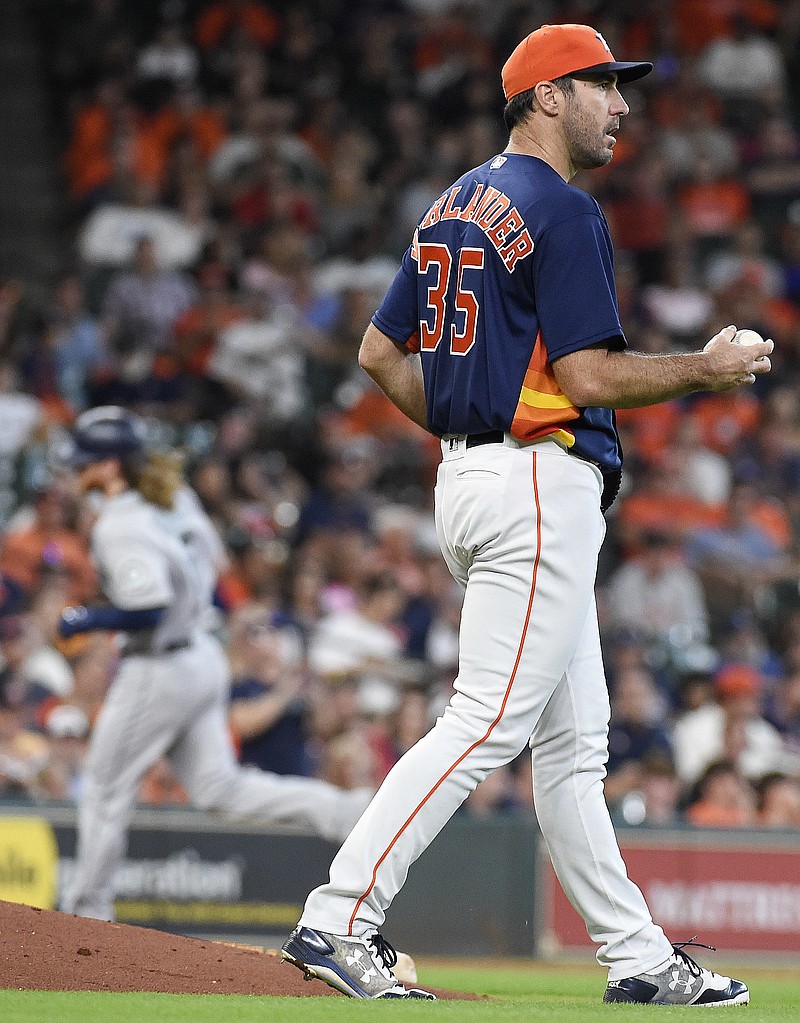 
              Houston Astros starting pitcher Justin Verlander, right, walks off the mound as Seattle Mariners' Ben Gamel, back left, rounds the bases after hitting a solo home run during the third inning of a baseball game, Sunday, Sept. 17, 2017, in Houston. (AP Photo/Eric Christian Smith)
            