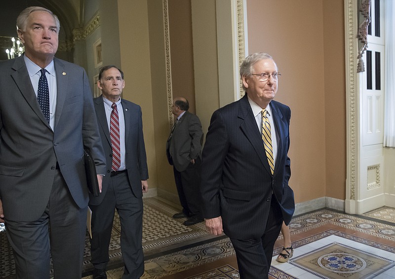 
              Senate Budget Committee members Sen. Luther Strange, R-Ala., left, and Sen. John Boozman, R-Ark., center, walk with Senate Majority Leader Mitch McConnell, R-Ky, right, as they leave a closed-door meeting with Treasury Secretary Steven Mnuchin after working on a tax code overhaul, at the Capitol in Washington, Tuesday, Sept. 12, 2017. The as-yet-undrafted bill to overhaul the tax code is the top priority for Trump and Republicans after the collapse of their effort to dismantle Barack Obama's health care law. (AP Photo/J. Scott Applewhite)
            