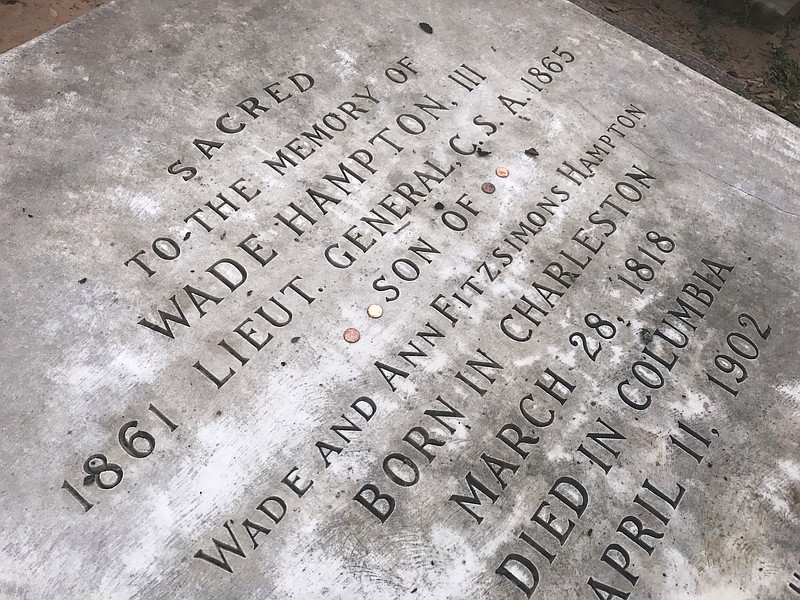 
              This Aug. 25, 2017, photo shows the gravestone of Confederate Gen. Wade Hampton in Columbia, S.C., at the Trinity Episcopal Cathedral. This is one of the churches nationwide wrestling with the question of what to do with emblems dotting their parishes that memorialize the former slaveholding states and their battle heroes. (AP Photo/Meg Kinnard)
            