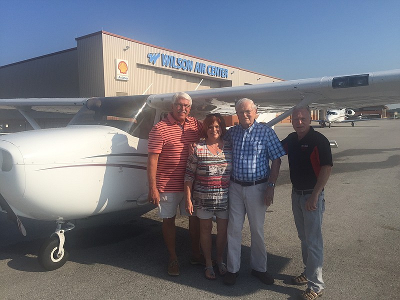 Darden Newman, third from left, stands in front of the plane he flew on his 92nd birthday as a gift from daughter and son-in-law John and Gail Cooke, at left, and son Steve Newman, at right.