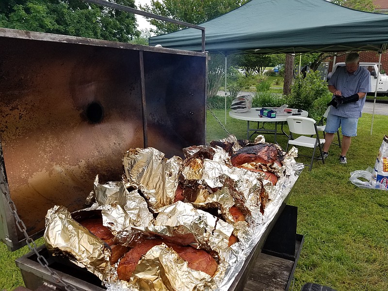 All of the food served at Daisy United Methodist Church's upcoming fundraiser will be homemade by members of the congregation. Here, church members smoke some of the roughly 100 pounds of pork they will serve on Saturday, Sept. 23. (Contributed Photo)
