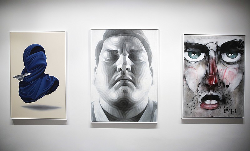 
              The paintings, from left: 'Shirt Mask x Paper Plane' by Numo Viegas, 'The Fighter' by El Mac and 'Street Face' by Lister displayed inside the exhibition of the new Urban Nation Museum for Urban Contemporary Art in Berlin, Germany, Monday, Sept. 18, 2017. The opening exhibition, which will last for around nine months, aims to introduce visitors to the culture of urban art. Director Yasha Young worked with eight curators from various countries to produce a show that explores strands including portraits, pop art and activism. (AP Photo/Markus Schreiber)
            