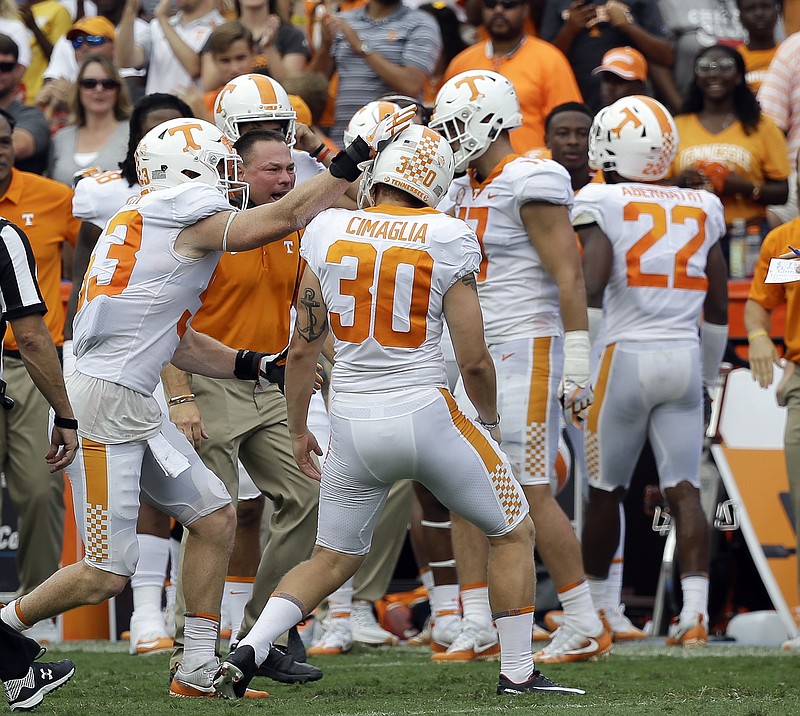 Tennessee place kicker Brent Cimaglia (30) celebrates with head coach Butch Jones and teammates after he kicked a 51-yard field goal during the first half of an NCAA college football game against Florida, Saturday, Sept. 16, 2017, in Gainesville, Fla. (AP Photo/John Raoux)