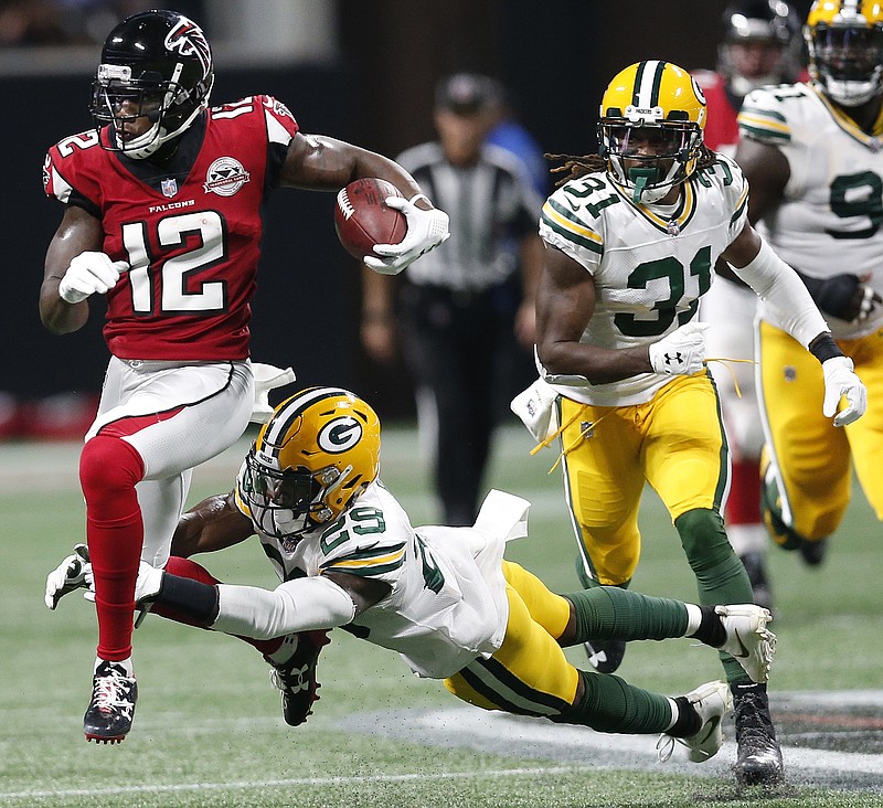 Atlanta Falcons wide receiver Mohamed Sanu (12) runs by Green Bay Packers defensive back Kentrell Brice (29) during the first of an NFL football game, Sunday, Sept. 17, 2017, in Atlanta. (AP Photo/John Bazemore)