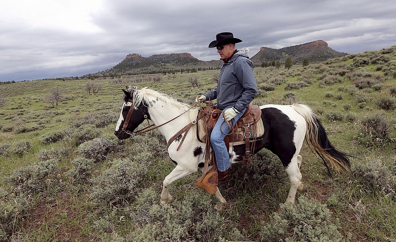 
              FILE - In this May 9, 2017, file photo, Interior Secretary Ryan Zinke rides a horse in the new Bears Ears National Monument near Blanding, Utah. Zinke is recommending that four large national monuments in the West be reduced in size, potentially opening up hundreds of thousand or even millions of acres of land revered for natural beauty and historical significance to mining, logging and other development. (Scott G Winterton/The Deseret News via AP, File)
            
