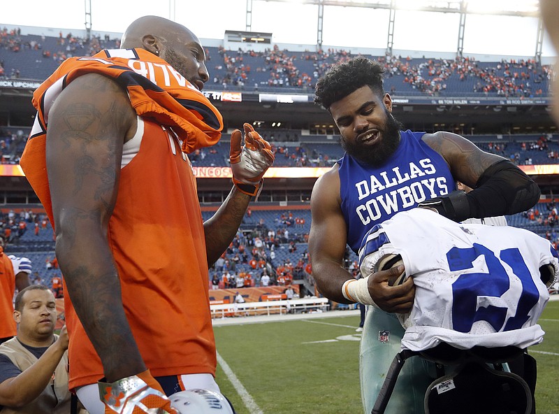 
              Dallas Cowboys running back Ezekiel Elliott, right, and Denver Broncos cornerback Aqib Talib exchange jerseys after an NFL football game, Sunday, Sept. 17, 2017, in Denver. The Broncos won 42-17. (AP Photo/Joe Mahoney)
            
