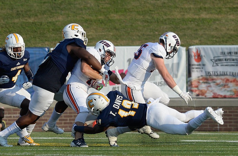 UTC's Isaiah Mack (8) and Tae Davis (19) tackle UT-Martin's Troy Cook during the game on Sept. 16, 2017.  (Photo by Mark Gilliland)