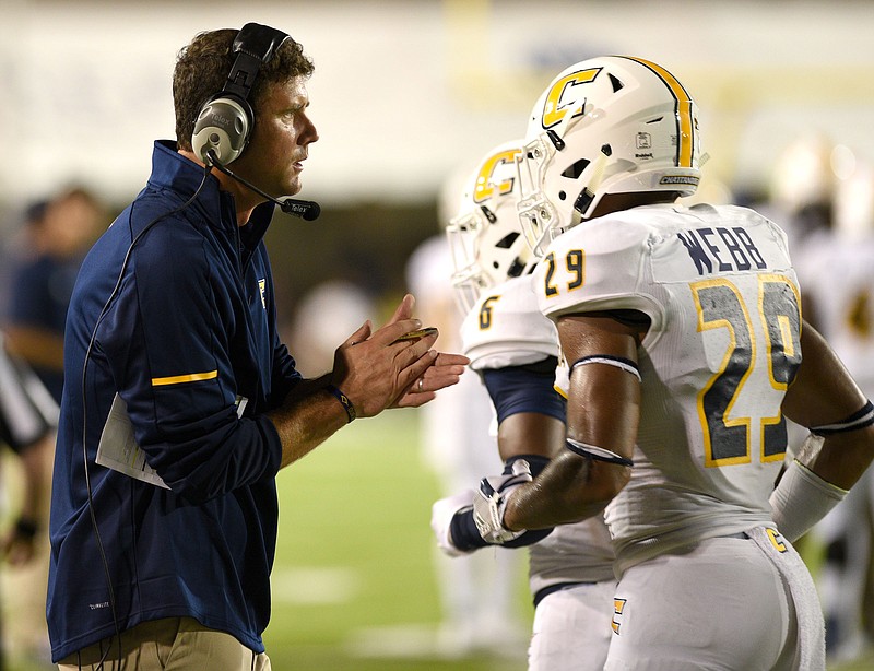 UTC head coach Tom Arth encourages his players as they come off the field. The Mocs met the Jacksonville State Gamecocks in the Guardian Credit Union FCS Kickoff at the Carmton Bowl in Montgomery, Ala., on Aug. 26, 2017.