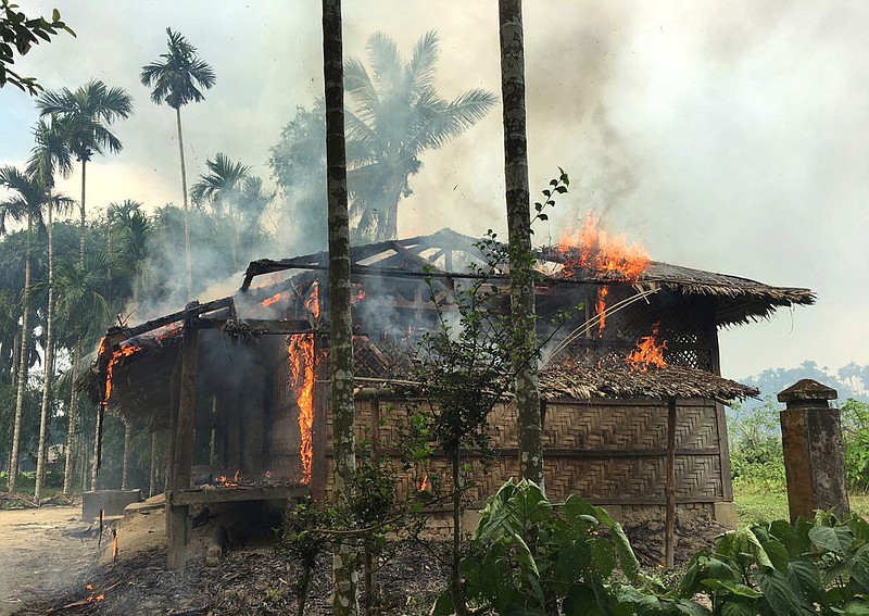 
              FILE - In this Sept. 7, 2017 file photo, flames engulf a house in Gawdu Zara village, northern Rakhine state, Myanmar. Security forces and allied mobs have burned down thousands of homes in Northern Rakhine state, where the vast majority of the country's 1.1 million Rohingya lived, in recent weeks. (AP Photo, File)
            
