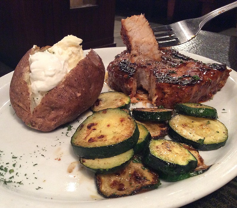 The Hickory Bourbon-Glazed Pork Chop comes with two sides.