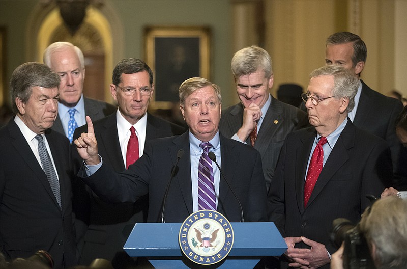 
              Sen. Lindsey Graham, R-S.C., joined by, from left, Sen. Roy Blunt, R-Mo., Majority Whip John Cornyn, R-Texas, Sen. John Barrasso, R-Wyo., Sen. Bill Cassidy, R-La., Senate Majority Leader Mitch McConnell, R-Ky., and Sen. John Thune, R-S.D., speaks to reporters as he pushes a last-ditch effort to uproot former President Barack Obama's health care law, at the Capitol in Washington, Tuesday, Sept. 19, 2017. To win, 50 of the 52 GOP senators must back it _ a margin they failed to reach when the chamber rejected the effort in July. (AP Photo/J. Scott Applewhite)
            