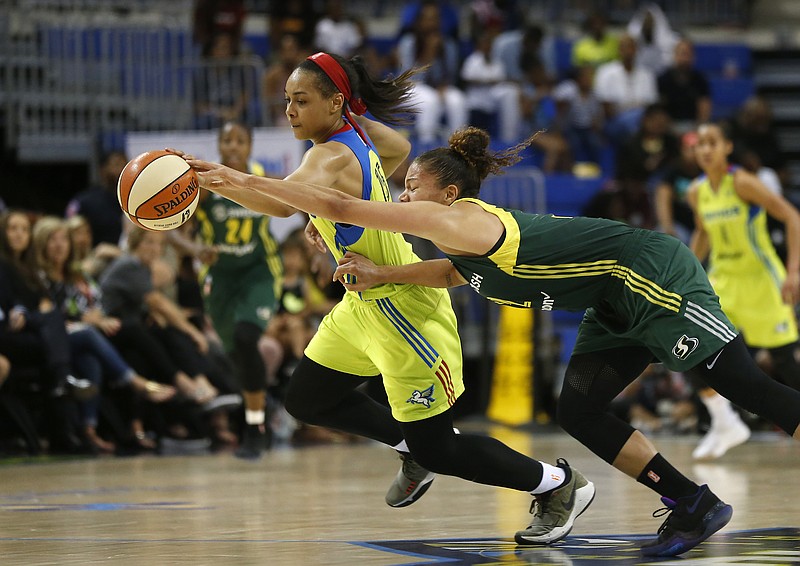 
              FILE - In this July 1, 2017, file photo, Dallas Wings guard Allisha Gray (15), rear left,  gets a loose ball against Seattle Storm forward Alysha Clark during the second half of a WNBA basketball game in Arlington, Texas. Dallas Wings guard Allisha Gray is the WNBA Rookie of the Year. The league announced Tuesday, Sept. 19, 2017, that Gray received 30 votes from a national media panel while Atlanta Dream guard Brittney Sykes got 10.  (Jae S. Lee/The Dallas Morning News via AP, File)
            