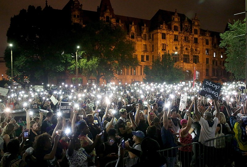 
              Hundreds of protesters stand outside of the St. Louis city jail on Monday, Sept. 18, 2017. The protesters chanted "free our people" outside the jail on Monday night to show solidarity with those who remain behind bars. Police said that more than 120 people were arrested during Sunday's protests. Monday was the fourth day of protests over the acquittal of a white former police officer in the killing of a black suspect. (David Carson/St. Louis Post-Dispatch via AP)
            