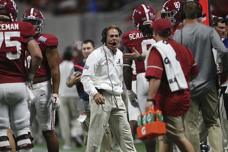 Alabama head coach Nick Saban speaks to players against Florida State during the first half of an NCAA football game, Saturday, Sept. 2, 2017, in Atlanta. (AP Photo/John Bazemore)