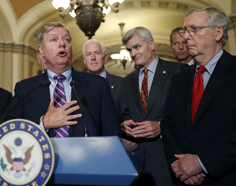 Sen. Lindsey Graham, R-S.C., speaks to the media, accompanied by Senate Majority Whip Sen. John Cornyn, R-Texas, Sen. Bill Cassidy, R-La., Sen. John Thune, R-S.D., and Senate Majority Leader Mitch McConnell of Ky., on Capitol Hill, Tuesday, Sept. 19, 2017, in Washington. (AP Photo/Alex Brandon)