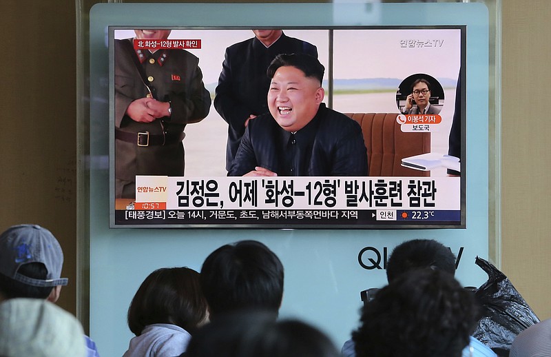 
              People watch a TV screen showing a local news program reporting about North Korea's missile launch with an image of North Korean leader Kim Jong Un, at the Seoul Railway Station in Seoul, South Korea, Saturday, Sept. 16, 2017. North Korea leader Kim said his country is nearing its goal of "equilibrium" in military force with the United States, as the United Nations Security Council strongly condemned the North's "highly provocative" ballistic missile launch over Japan on Friday. The signs read "Kim Jong Un attends the launch of the Hwasong-12 missile." (AP Photo/Ahn Young-joon)
            