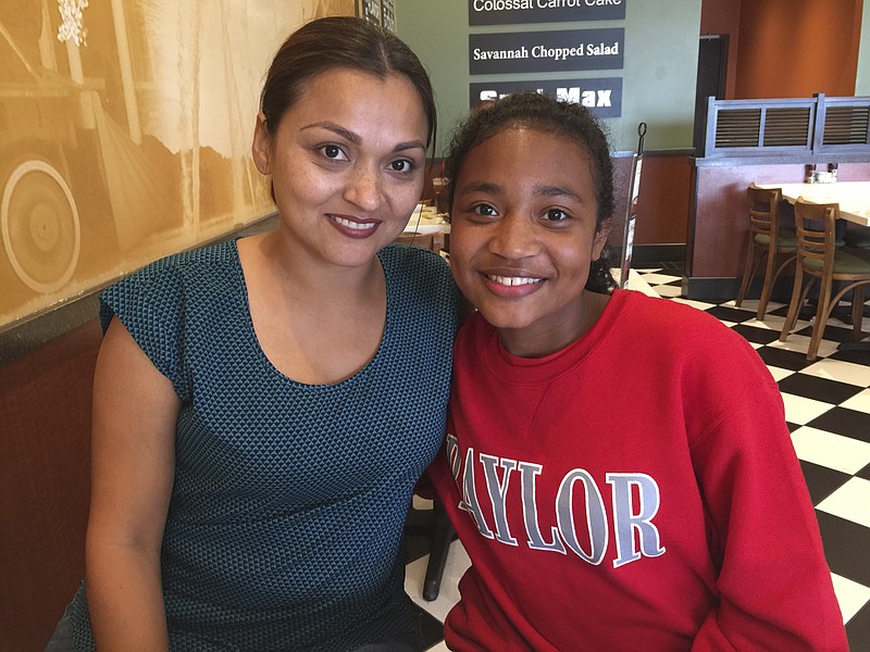 Maria Justice, left, has overcome a rocky childhood, and her daughter, Olivia Cranford, 11, now attends Baylor School.

