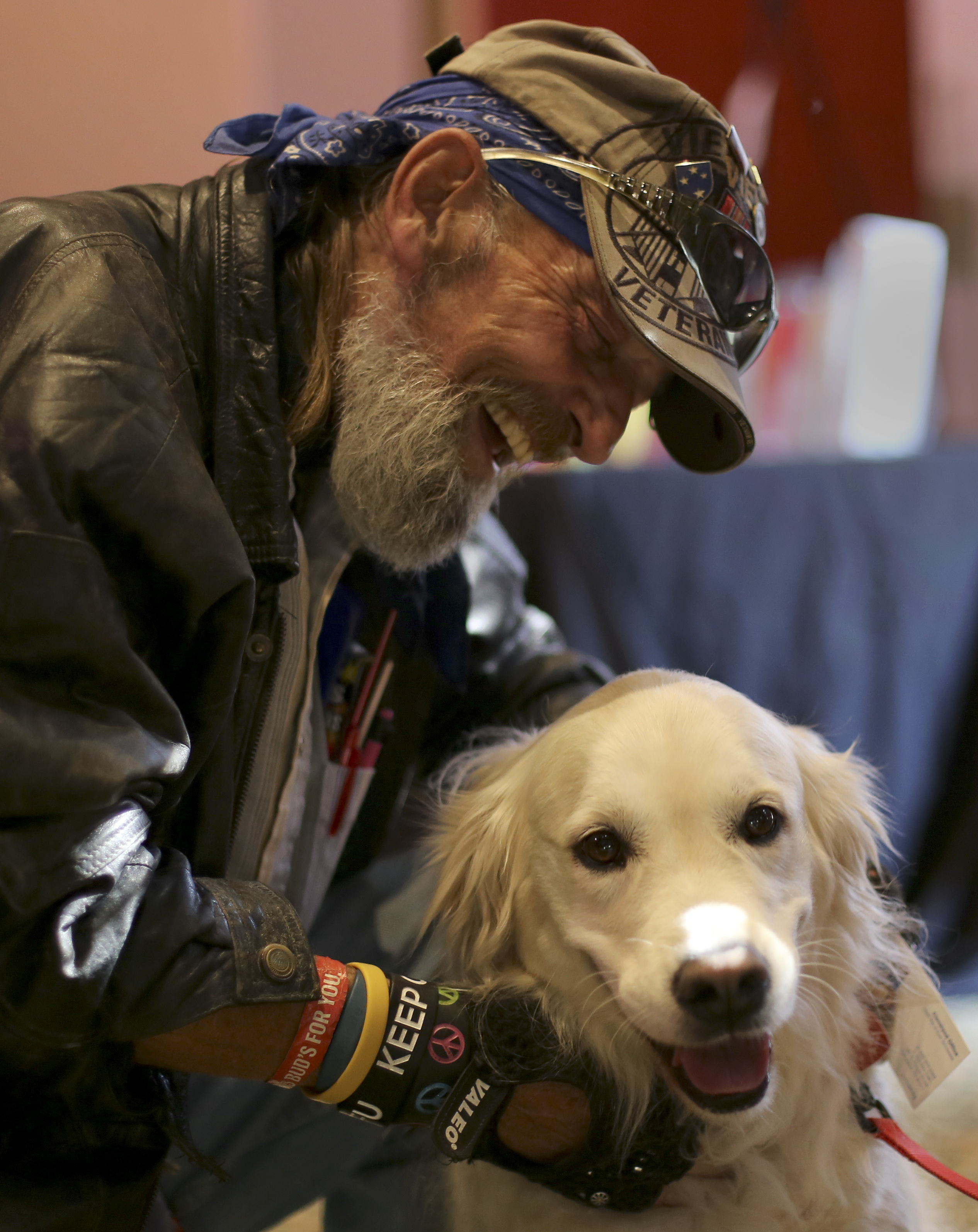 Army veteran James E. Dillon III pets Tessa, a 6-year-old golden retriever therapy dog, during the "Joint Operation" event at the Museum Center at 5ive Points on Wednesday, Sept. 20, in Cleveland, Tenn. The free event was open to all Tennessee veterans and their families and featured more than 45 agencies and organizations with information on a number of resources, including VA claim assistance, vocational rehabilitation, education, employment, mental health, housing, legal assistance and more.