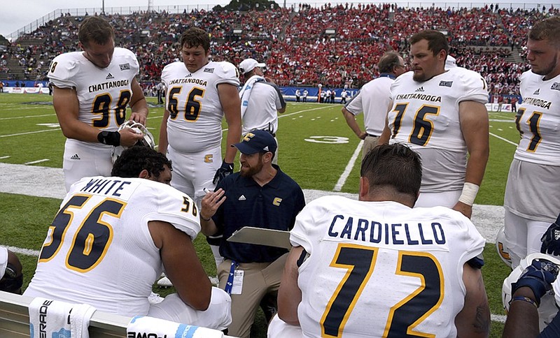 UTC offensive line coach Nick Hennessey talks to his players during the season opener against Jacksonville State. The Mocs are 0-3 as they adjust to different offensive and defensive schemes under a new coaching staff.