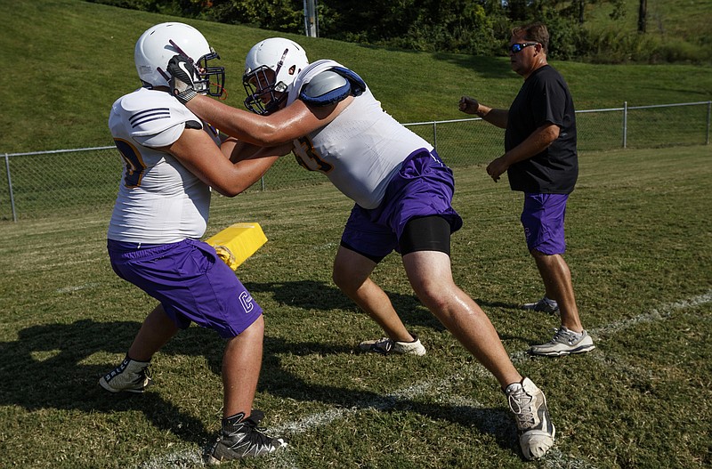 Central offensive lineman Wyatt Garrett, center, practices with a teammate during the Pounders' football practice at Central High School on Wednesday, Sept. 20, 2017, in Harrison, Tenn. The six-foot-ten and 350-pound lineman stands a head taller than the rest of the team's offensive line.